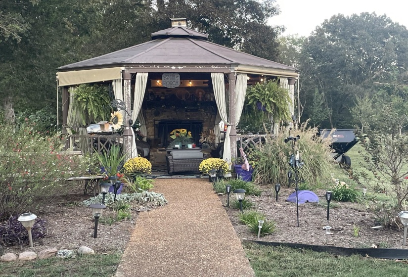 View of patio / terrace featuring a gazebo and view of scattered trees