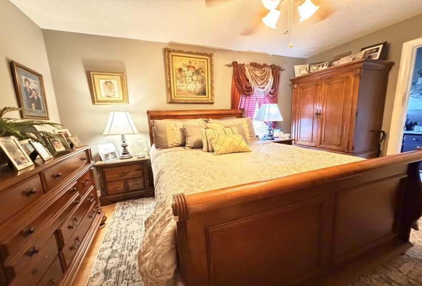 Bedroom with ceiling fan and a textured ceiling