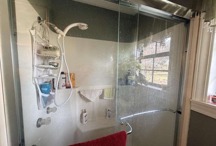 Full bathroom featuring a stall shower