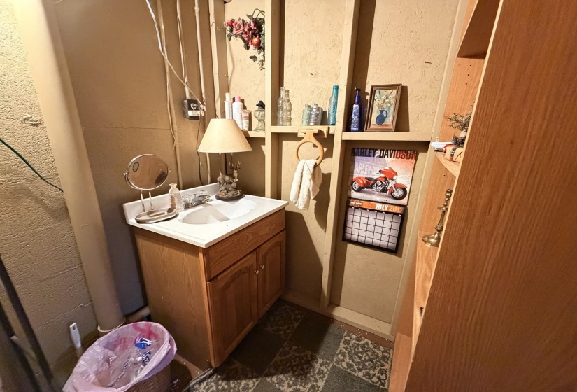 Bathroom featuring vanity and a textured wall