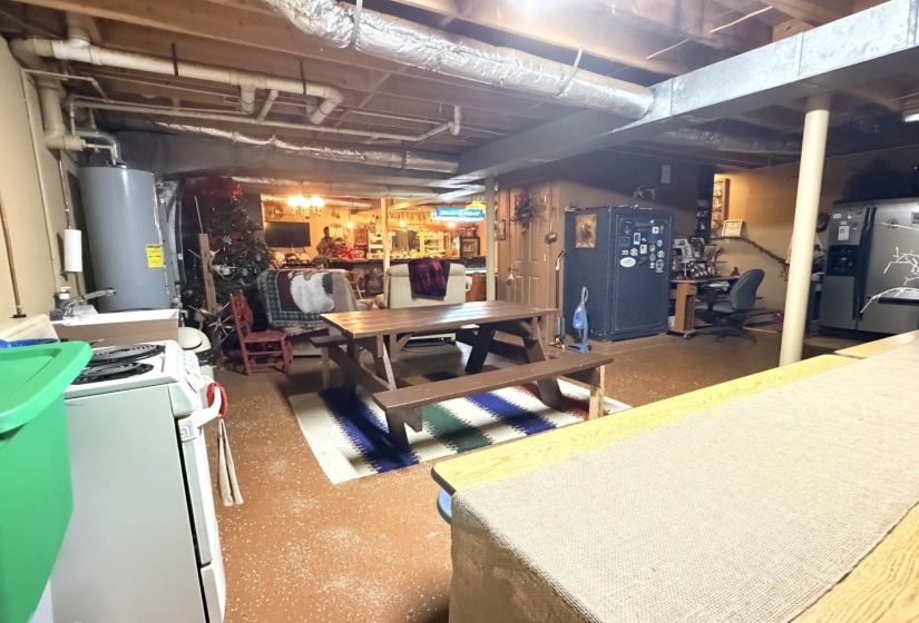Unfinished basement with water heater and washer / dryer