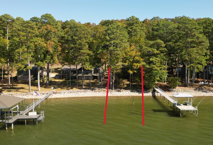Dock area featuring boat lift and a water view