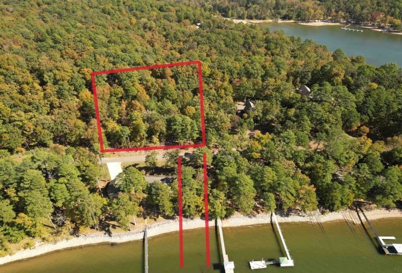 Aerial overview of property's location with a nearby body of water and property parcel outlined