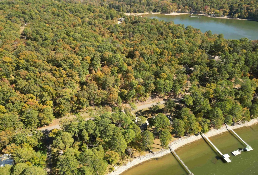 Aerial view of property and surrounding area featuring a large body of water
