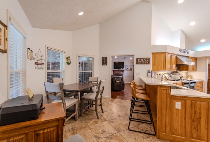 Dining room with high vaulted ceiling and recessed lighting