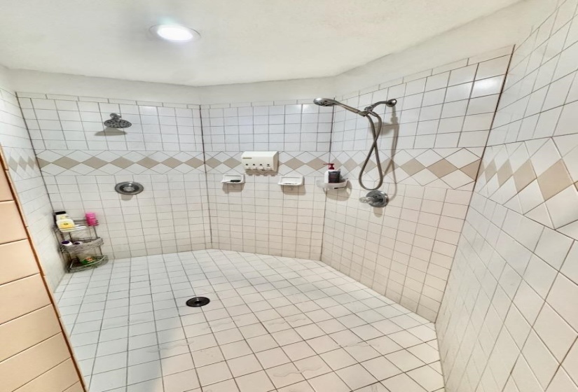 Full bath featuring tiled shower