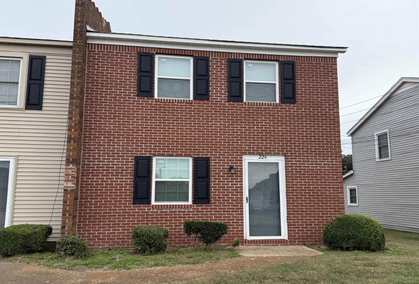 Traditional-style home featuring brick siding