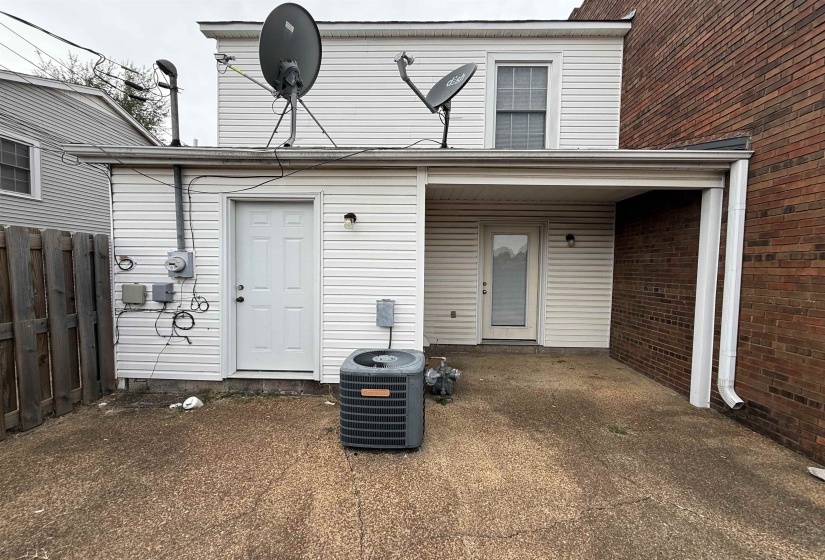 Property entrance featuring brick siding
