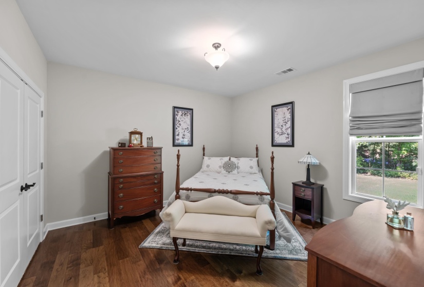 Bedroom featuring dark wood-style flooring and a closet