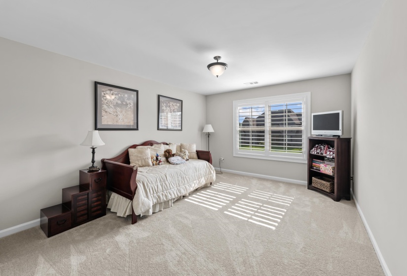 Carpeted bedroom featuring baseboards