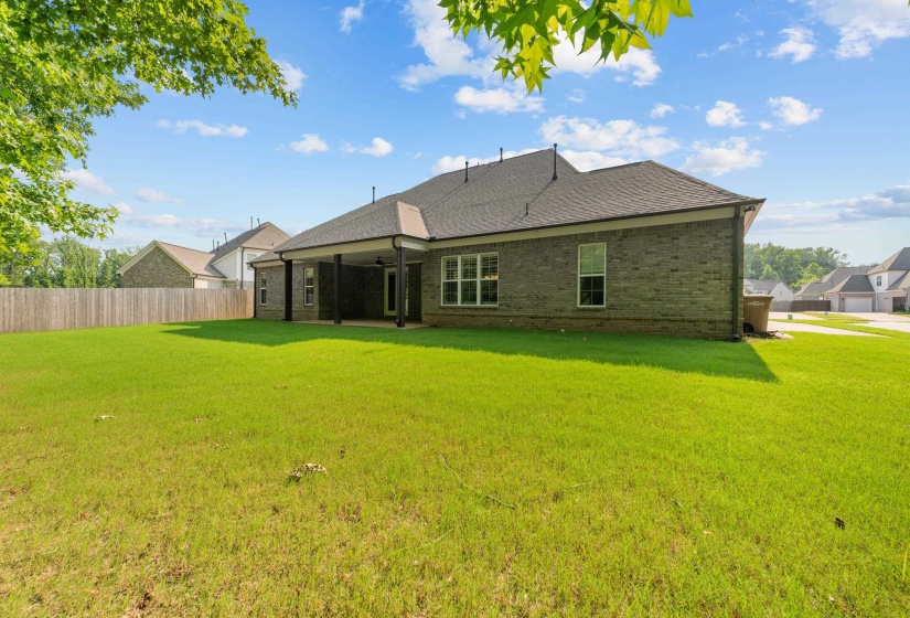 Back of house featuring brick siding, a ceiling fan, and a shingled roof