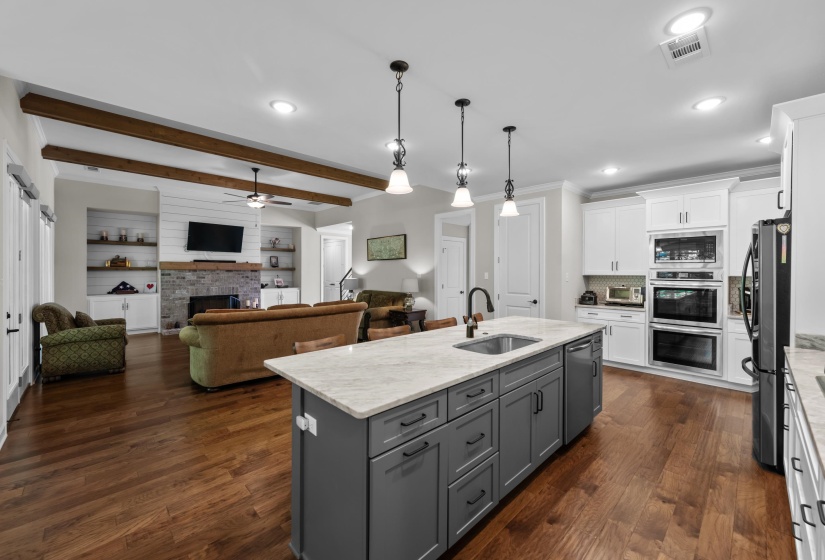 Kitchen featuring gray cabinetry, stainless steel appliances, white cabinetry, ceiling fan, and dark wood finished floors