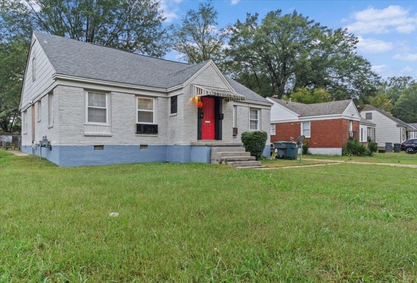 View of front of house featuring a front lawn, brick siding, and a shingled roof