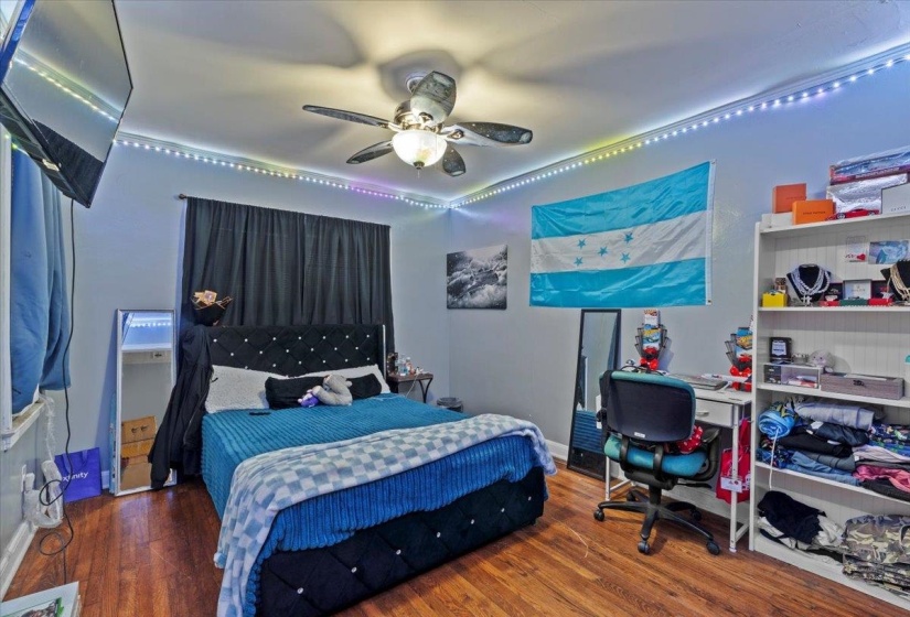 Bedroom featuring wood finished floors and a ceiling fan
