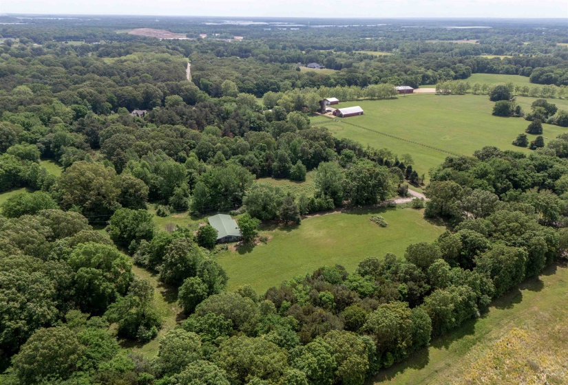 Aerial view of sparsely populated area featuring a forest