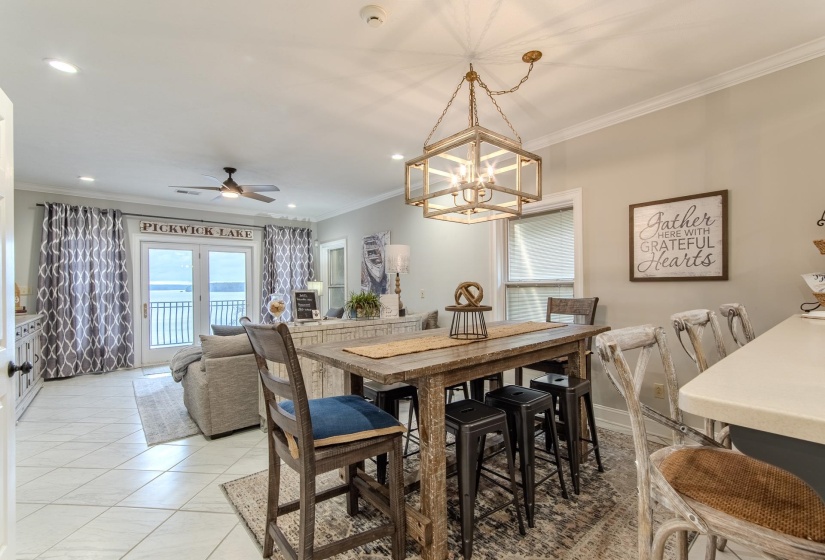Dining space featuring crown molding, ceiling fan, light tile patterned flooring, recessed lighting, and a chandelier