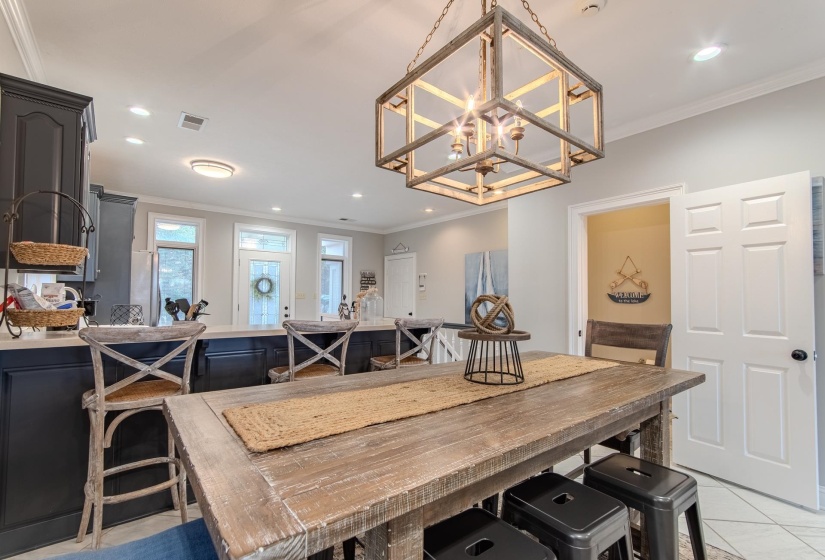 Dining area featuring crown molding, light tile patterned flooring, and recessed lighting
