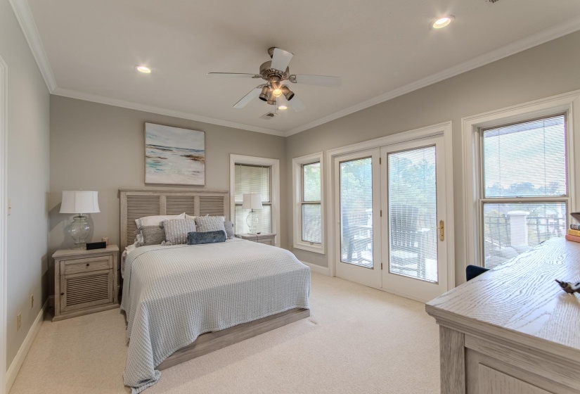 Bedroom featuring crown molding, light carpet, access to exterior, a ceiling fan, and recessed lighting