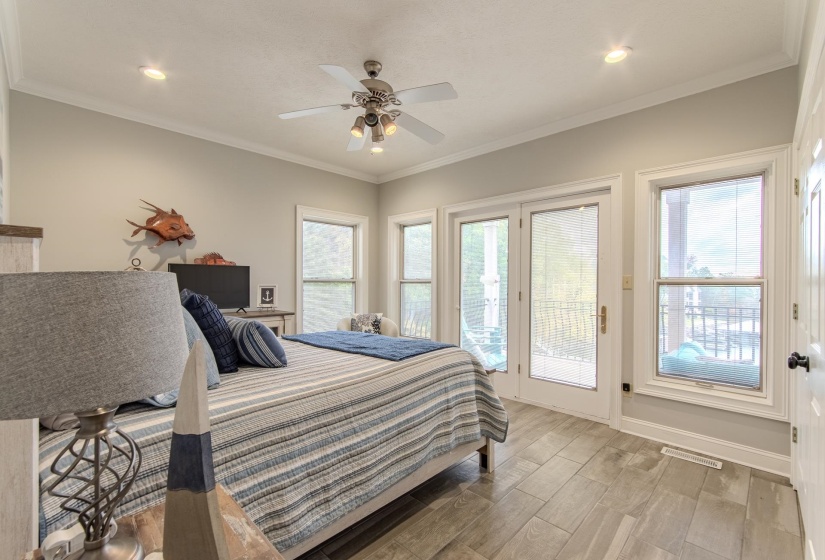 Bedroom featuring crown molding, wood finished floors, a ceiling fan, access to exterior, and recessed lighting