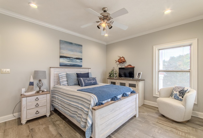 Bedroom with ornamental molding, light wood finished floors, recessed lighting, and a ceiling fan