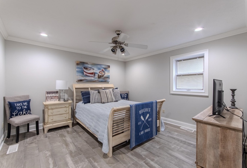 Bedroom with ornamental molding, light wood-style floors, a ceiling fan, and recessed lighting