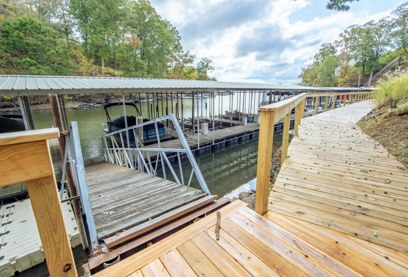 Dock area with a water view and boat lift
