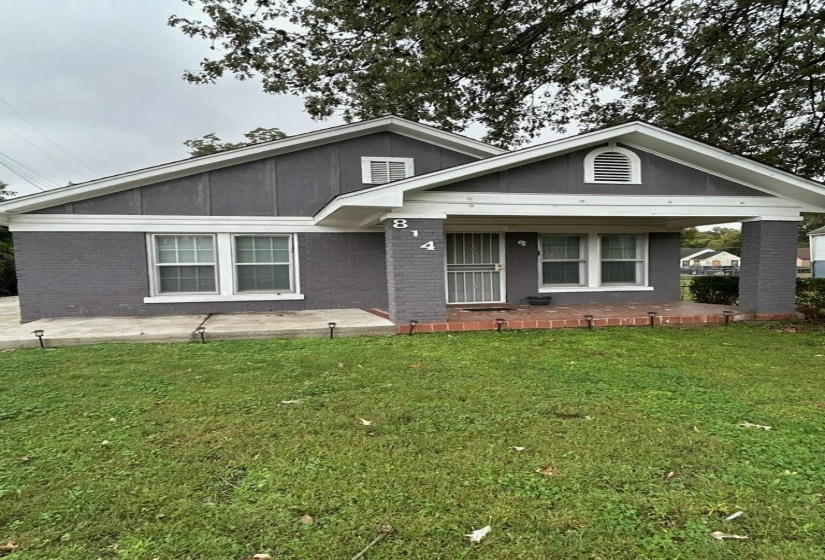 View of front of home featuring a front yard and brick siding