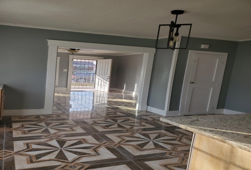 Interior space featuring ornamental molding, a textured ceiling, and ceiling fan with notable chandelier