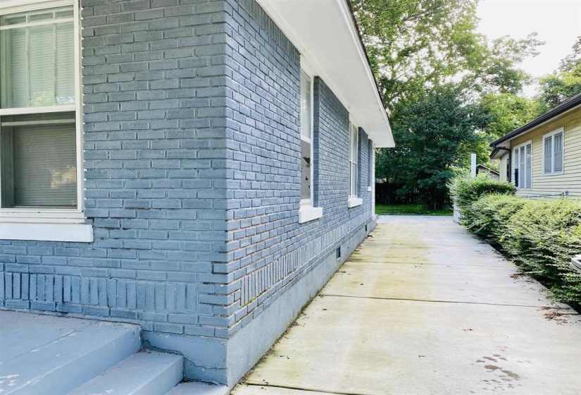 View of home's exterior featuring brick siding and crawl space