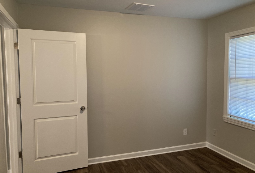 Empty room with baseboards and dark wood finished floors