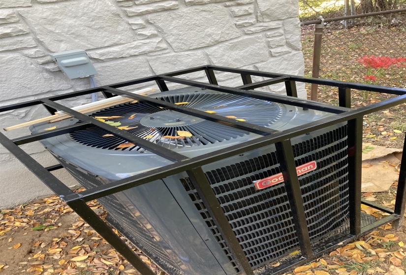 Exterior view of a cooling unit and stone siding