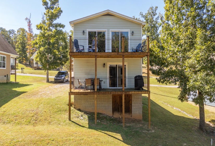 Back of property with a lawn
