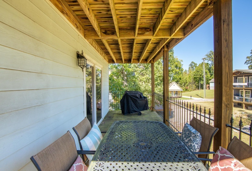 View of patio with grilling area, a wooden deck, and outdoor dining space