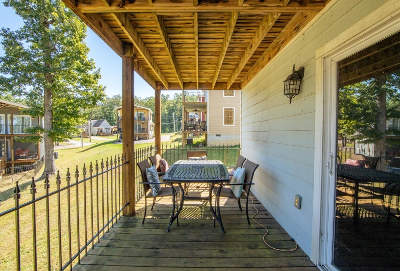 Wooden deck featuring outdoor dining area and a yard
