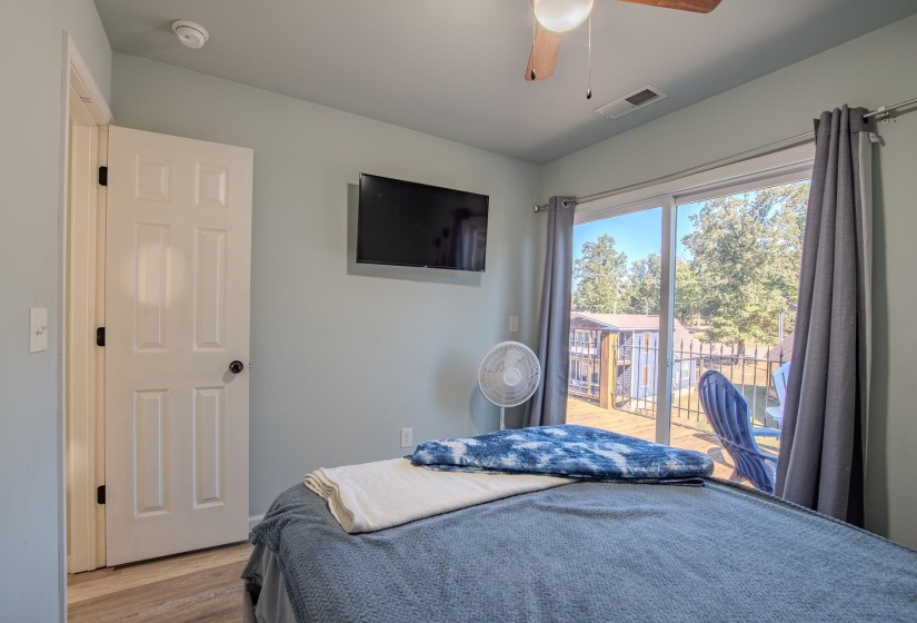 Bedroom featuring wood finished floors, access to outside, and a ceiling fan