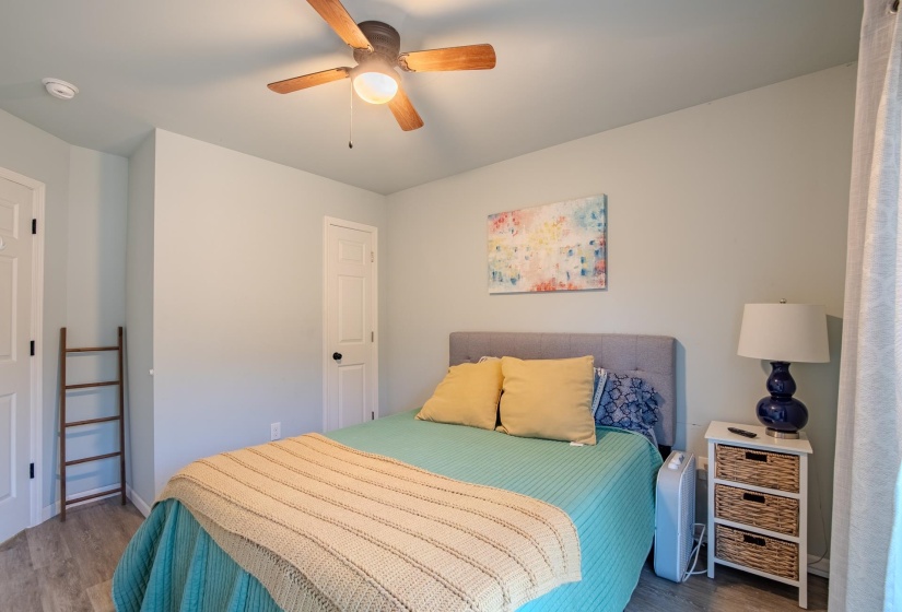 Bedroom with wood finished floors and a ceiling fan