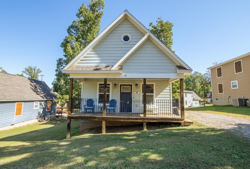 View of front of house with a front yard and a porch