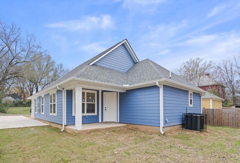 Bungalow featuring a shingled roof and a patio area