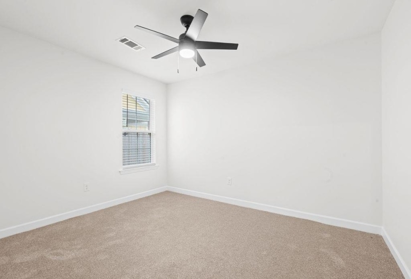Carpeted empty room with baseboards and ceiling fan
