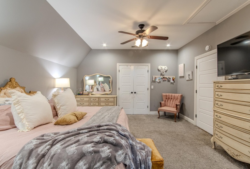 Carpeted bedroom featuring a closet, ceiling fan, recessed lighting, and vaulted ceiling