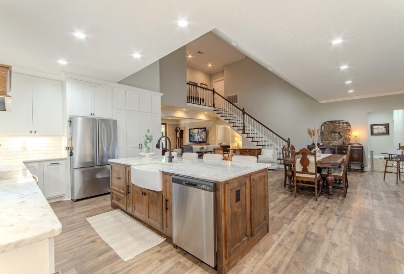 Kitchen featuring white cabinetry, stainless steel appliances, light stone countertops, light wood-style flooring, and recessed lighting
