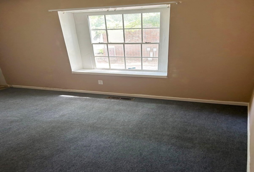 Empty room with carpet and baseboards