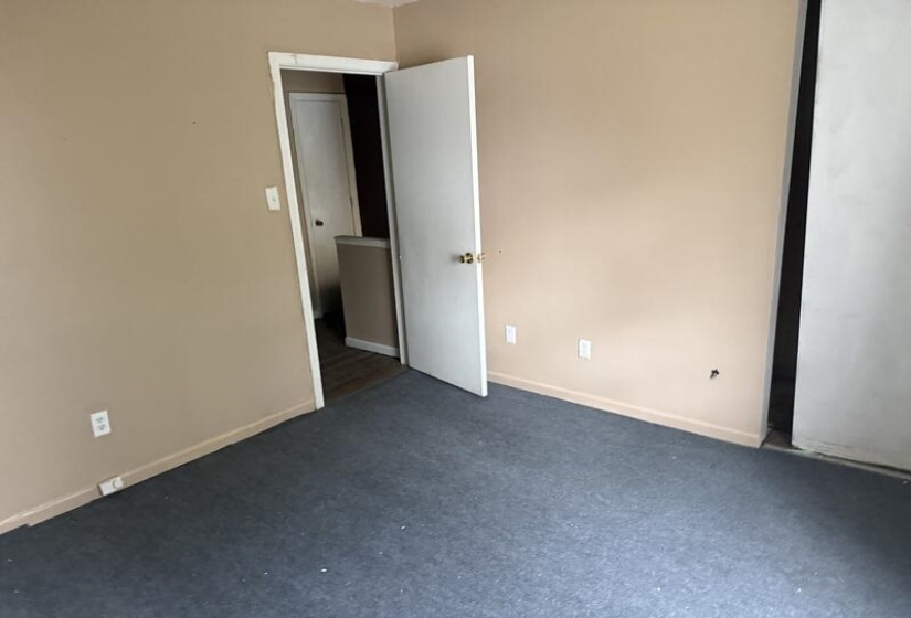 Empty room featuring baseboards and carpet floors