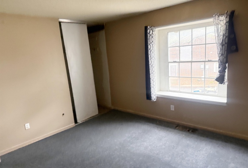 Spare room featuring baseboards and carpet flooring