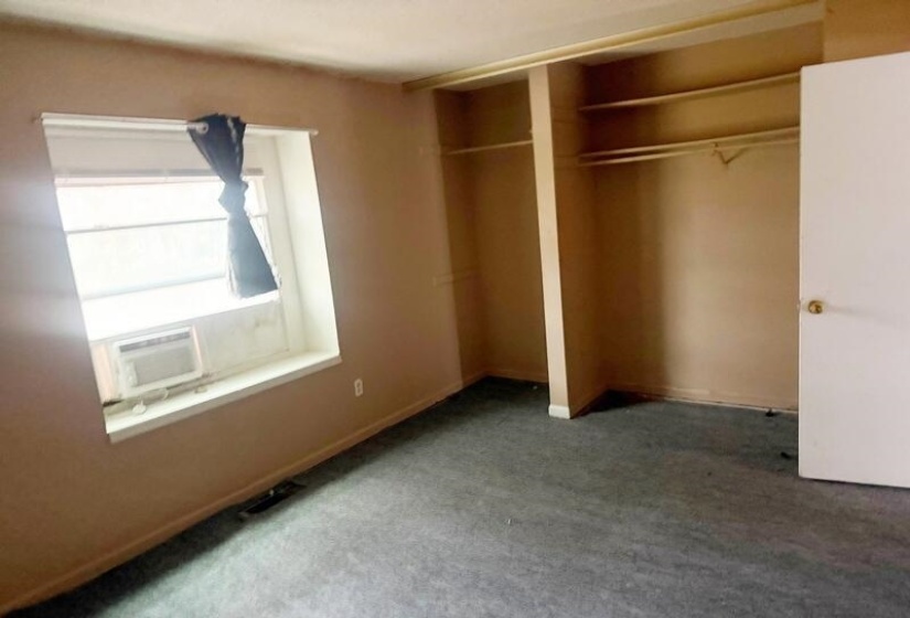 Unfurnished bedroom featuring carpet floors and a closet