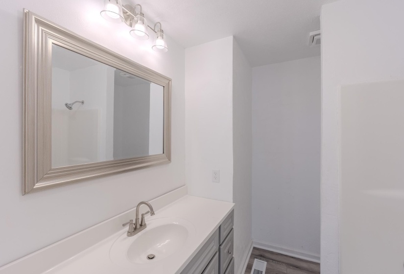 Bathroom with vanity and light wood-style floors