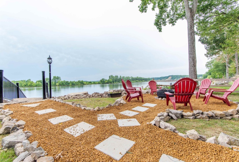 View of yard featuring a water view, a fire pit, and a patio