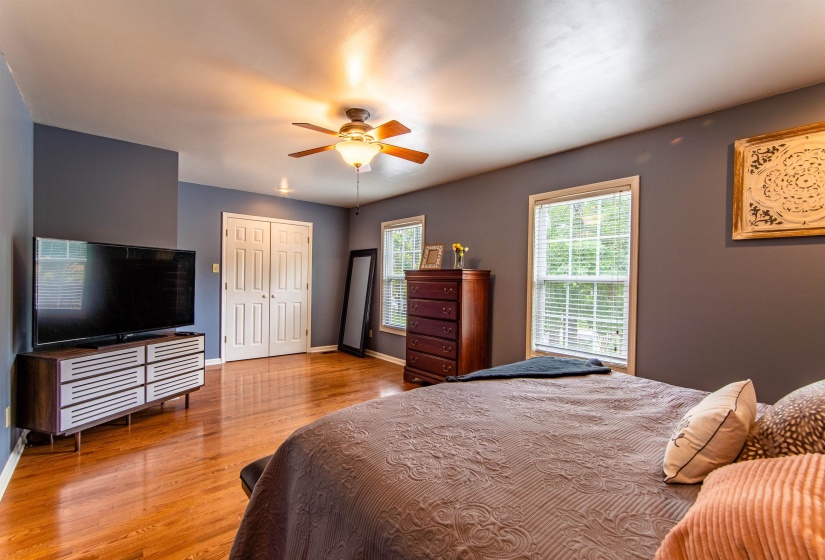 Bedroom with light wood-style flooring, a closet, and ceiling fan