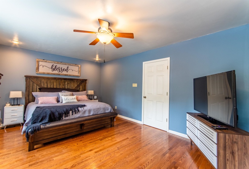 Bedroom with light wood finished floors and a ceiling fan
