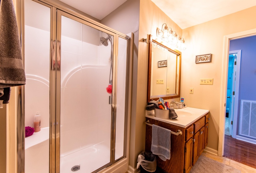 Bathroom with vanity and a stall shower